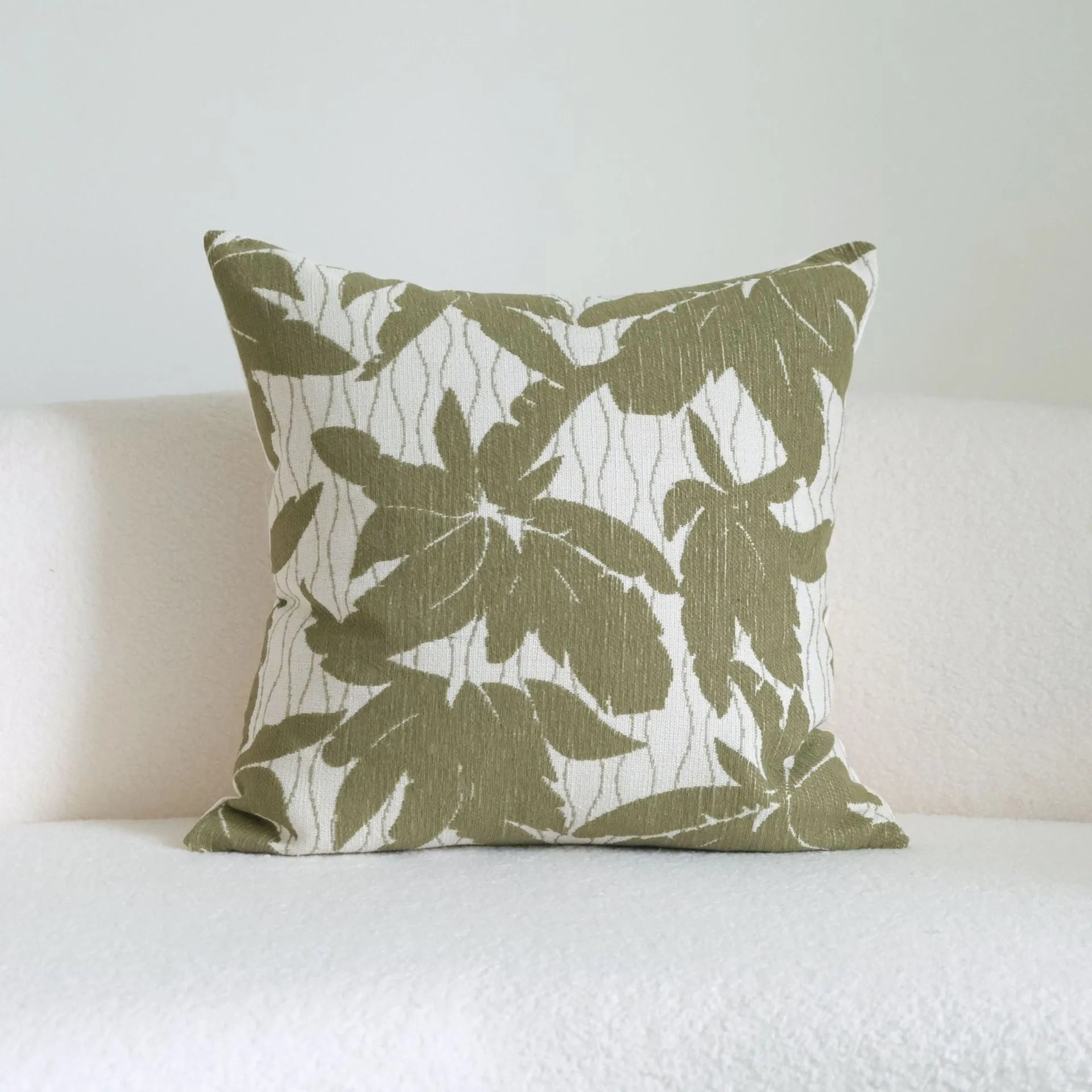 Green striped cotton linen hotel sample pillow with silk floss filler on a bed display.