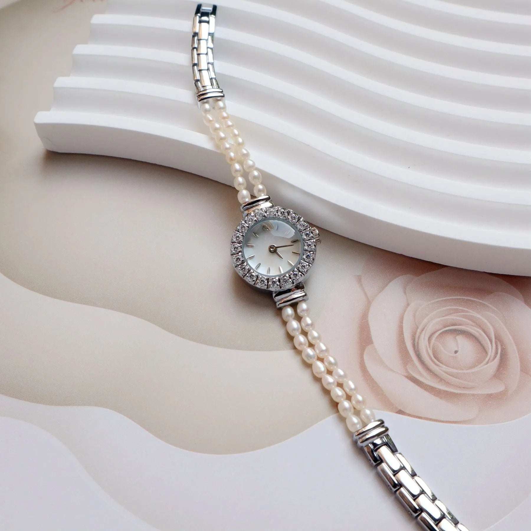 Women's light gold bracelet watch with freshwater pearl band and 18mm round dial