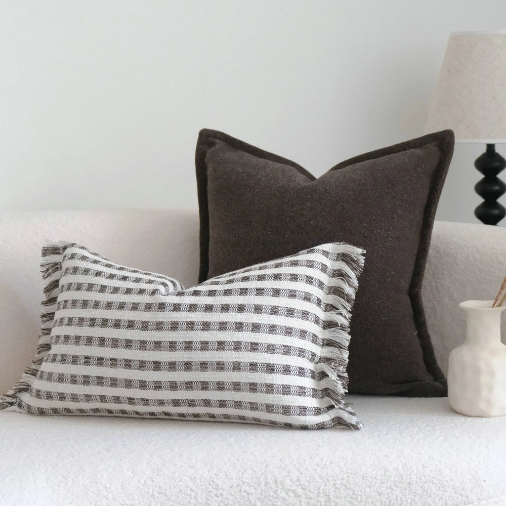 Coffee brown striped decorative cushion on a sofa in Chinese classical mid-century modern style.
