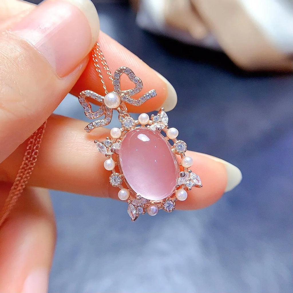 Pink rose quartz crystal pendant on silver necklace with rose gold plating geometric design