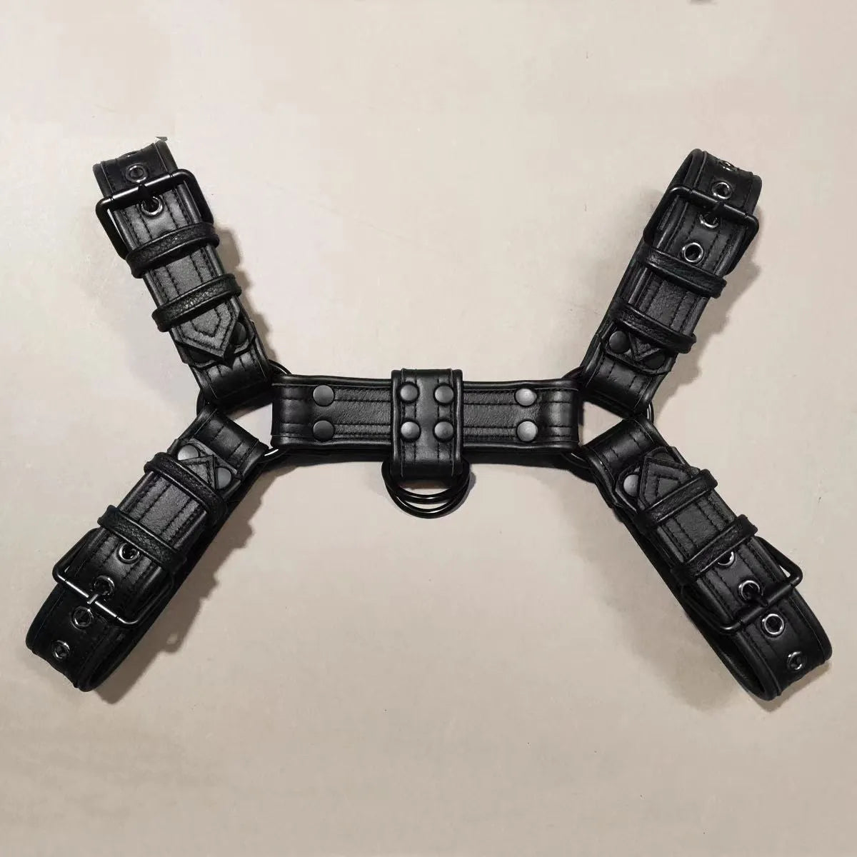 Black leather chest harness with adjustable shoulder straps and metal buckle fastenings