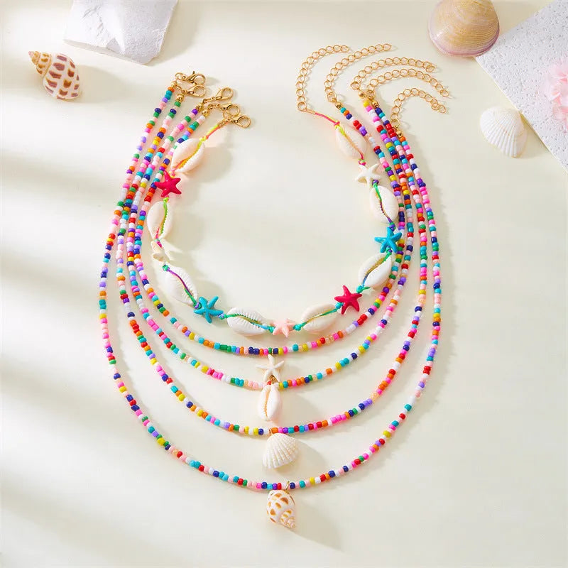 Five multi-layer women's necklaces with shell, starfish and conch beads on adjustable chains