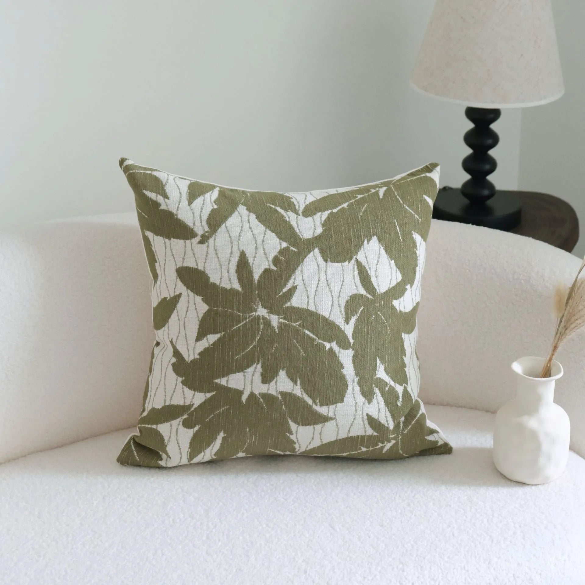 Green striped cotton linen hotel sample pillow with silk floss filler on a bed display.