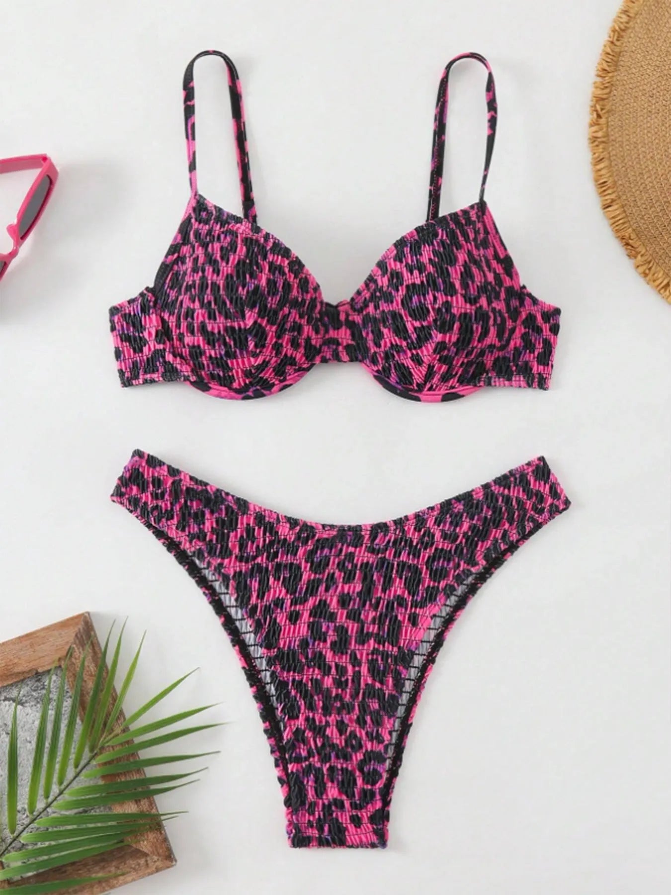 Women's leopard print bikini set with backless triangle top and briefs in brown and red colour mixes.