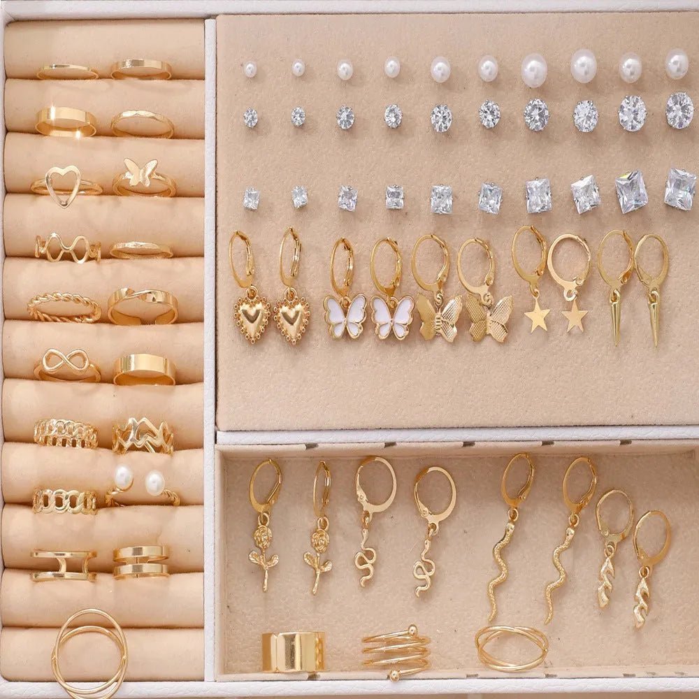 108 geometric round pearl earrings in gold and yellow electroplated alloy finishes displayed as a collection