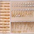 108 geometric round pearl earrings in gold and yellow electroplated alloy finishes displayed as a collection