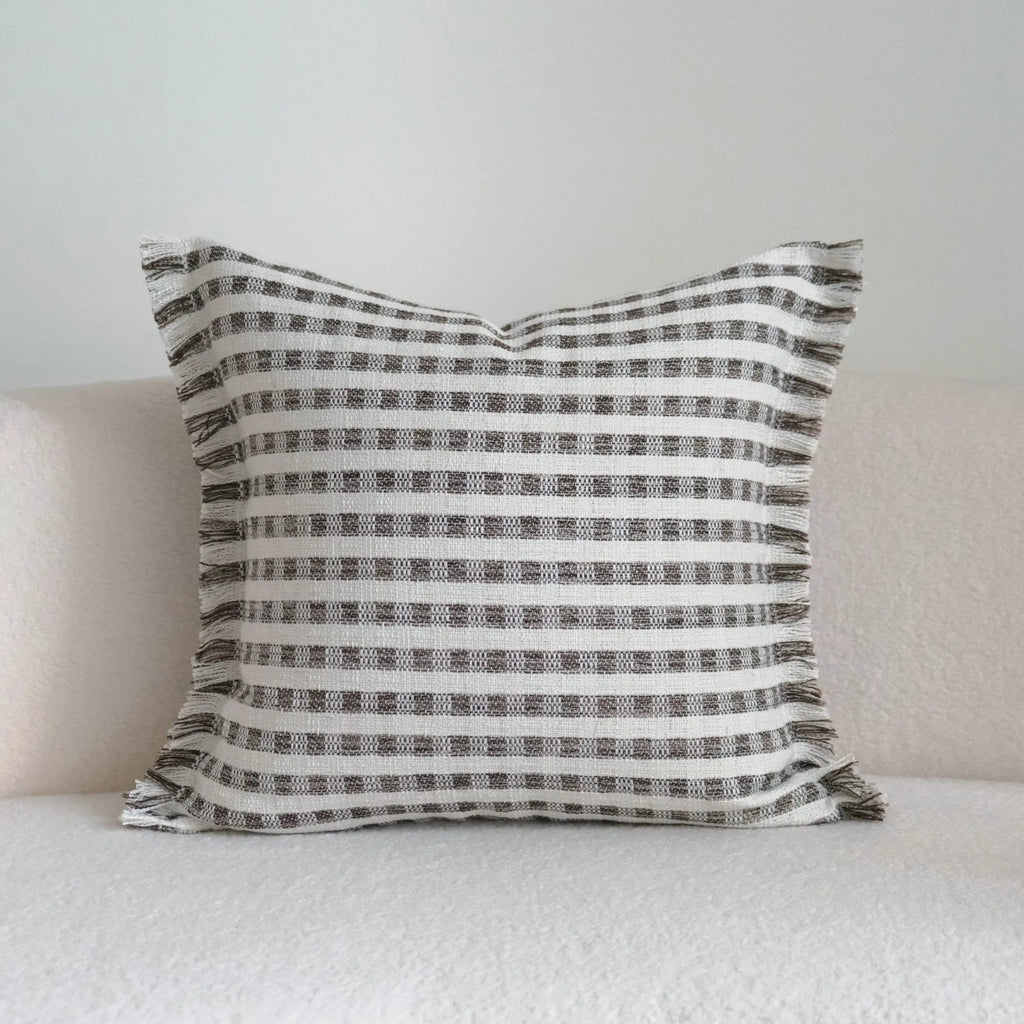 Coffee brown striped decorative cushion on a sofa in Chinese classical mid-century modern style.