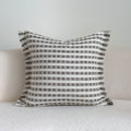 Coffee brown striped decorative cushion on a sofa in Chinese classical mid-century modern style.