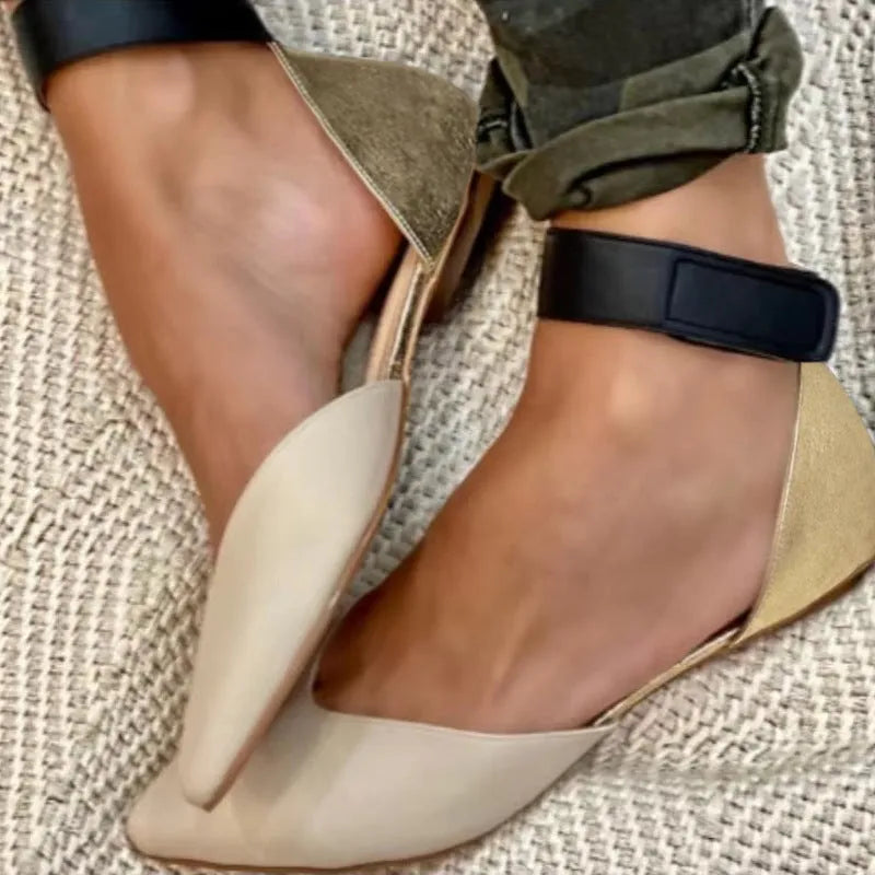 Women's beige flat sandals with a Velcro strap and hollowed PU leather upper on a white background.
