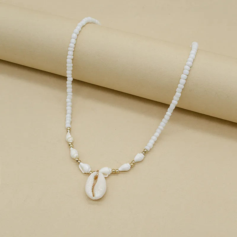 White mother pearl shellfish conch bead necklace with electroplated finish and shell pendant on regular chain