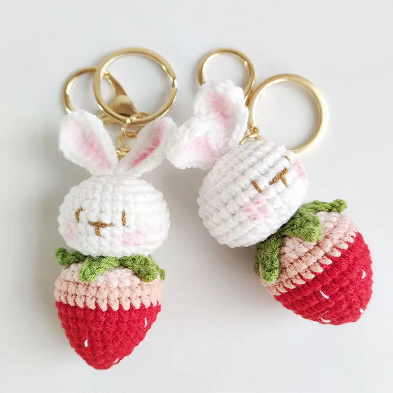 Hand-woven rabbit strawberry wire pendant with key attachment on white background