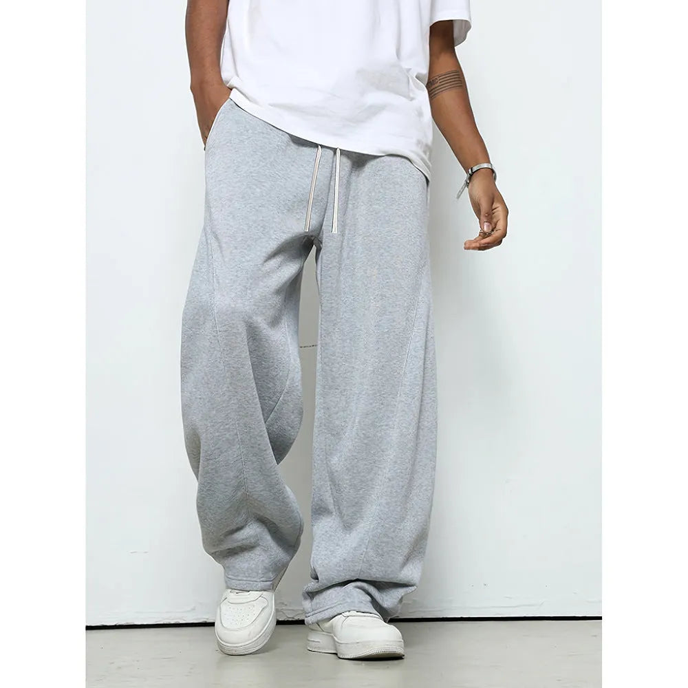 Men's grey casual trousers with drawstring waist and straight leg design on hanger