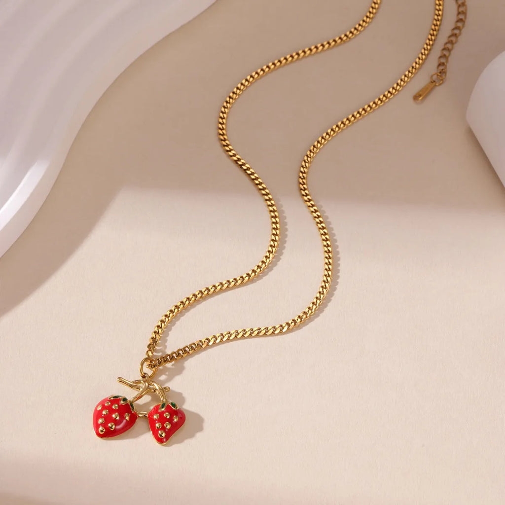 Stainless steel strawberry pendant necklace on a chain, shown in red and white gradient colour options.
