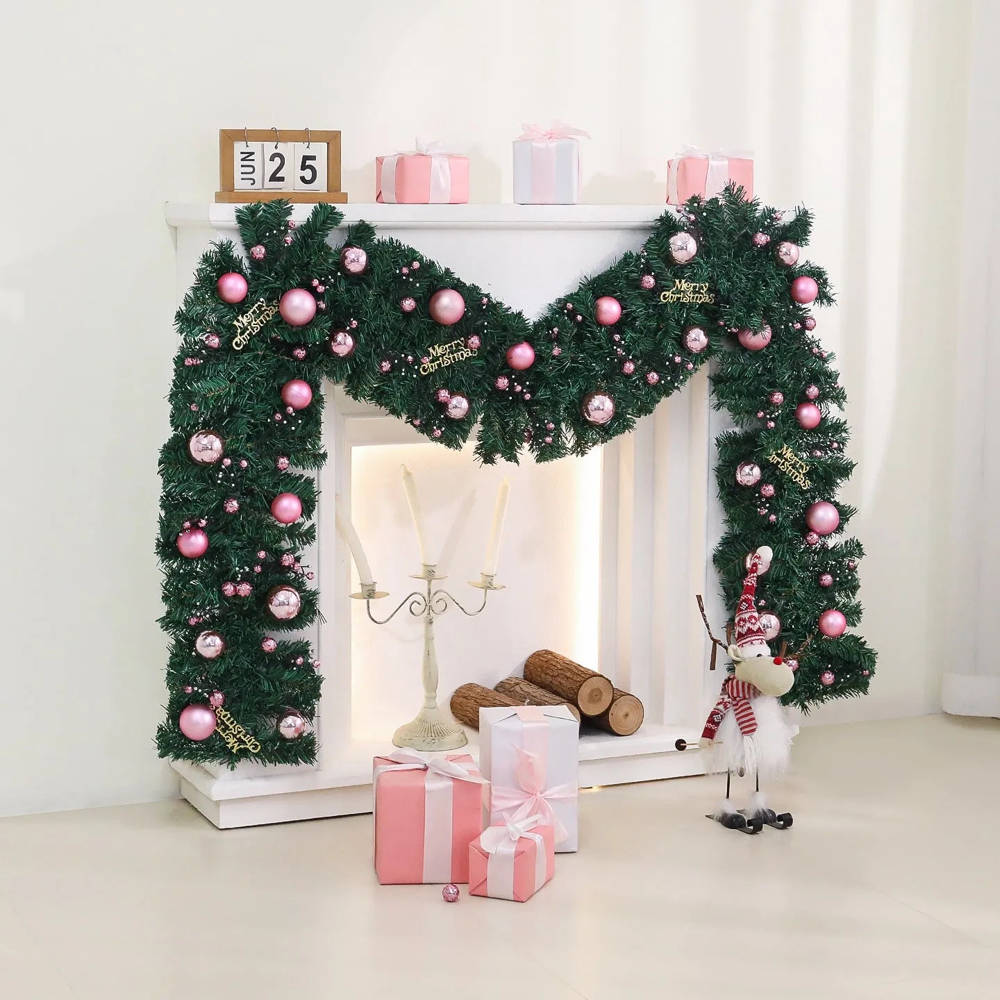 A long, pink artificial rattan Christmas garland with small fruits and leaves, shown draped decoratively.