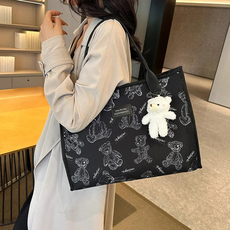 Women's canvas tote bag with printed rhombus pattern in black colour with pendant attachment