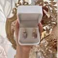 Natural freshwater pearl square stud earrings with geometric retro design in purple colour on alloy base.