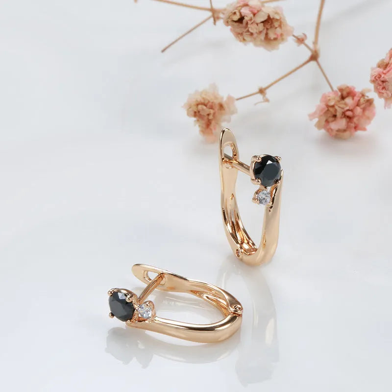 Gold drop-shaped women's earrings with a black agate stone inlay and retro geometric design.