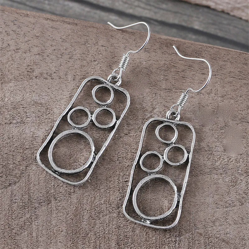 Round geometric earrings with irregular square designs in antique silver finish