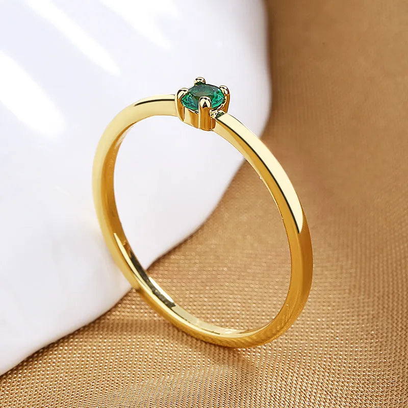 A simple copper geometric circle ring for women featuring a single diamond, shown on a hand.