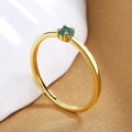 A simple copper geometric circle ring for women featuring a single diamond, shown on a hand.