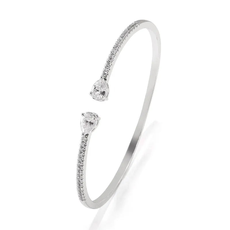 Copper bracelet with inlaid zircon detailing in simple style, shown in white and blue colour options.