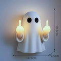 White plastic ghost night lamp with light on, on a flat surface