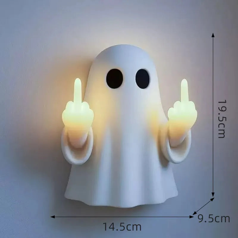 White plastic ghost night lamp with light on, on a flat surface