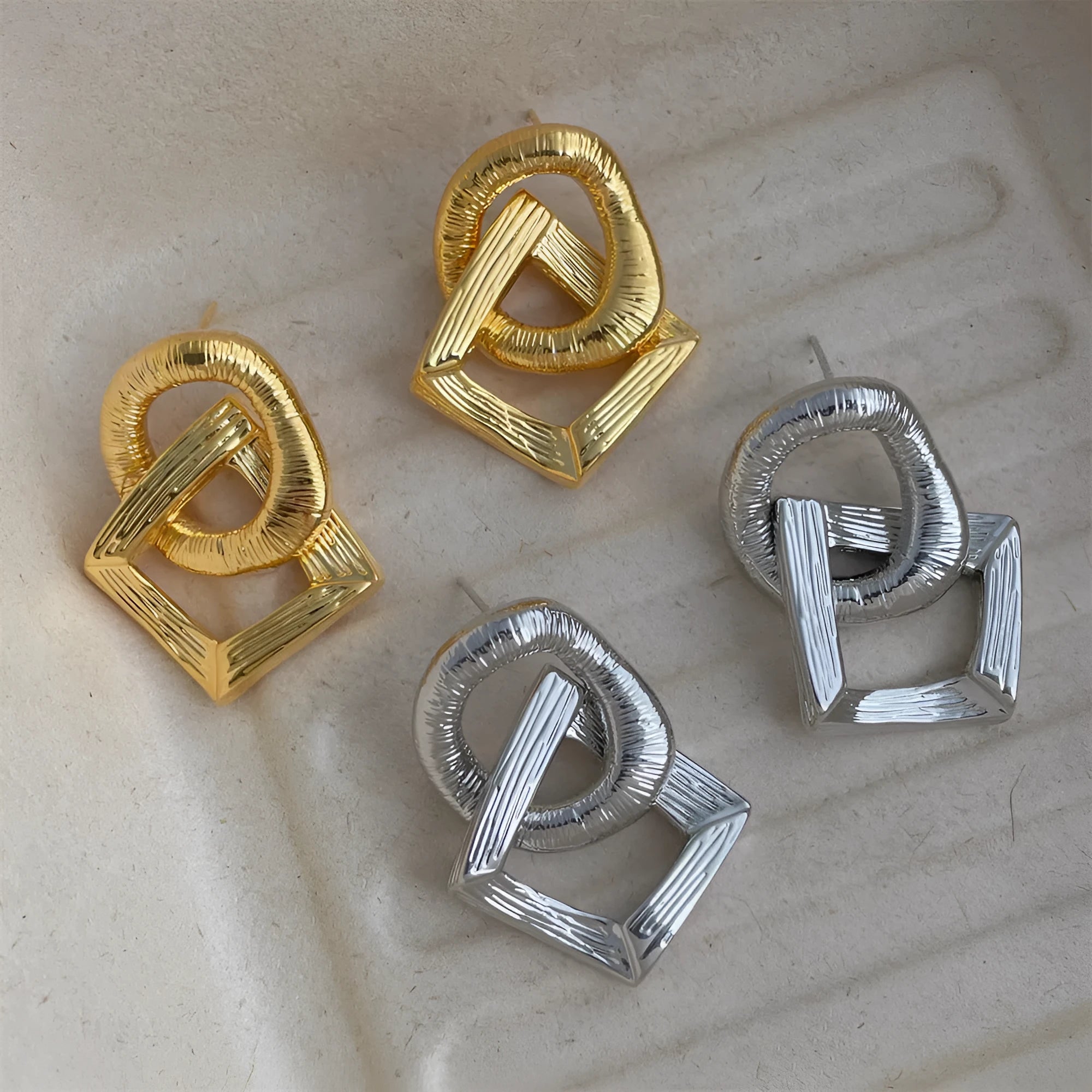 A pair of retro-style geometric circle pendant drop earrings with a 3.4cm length in a gold electroplated finish.
