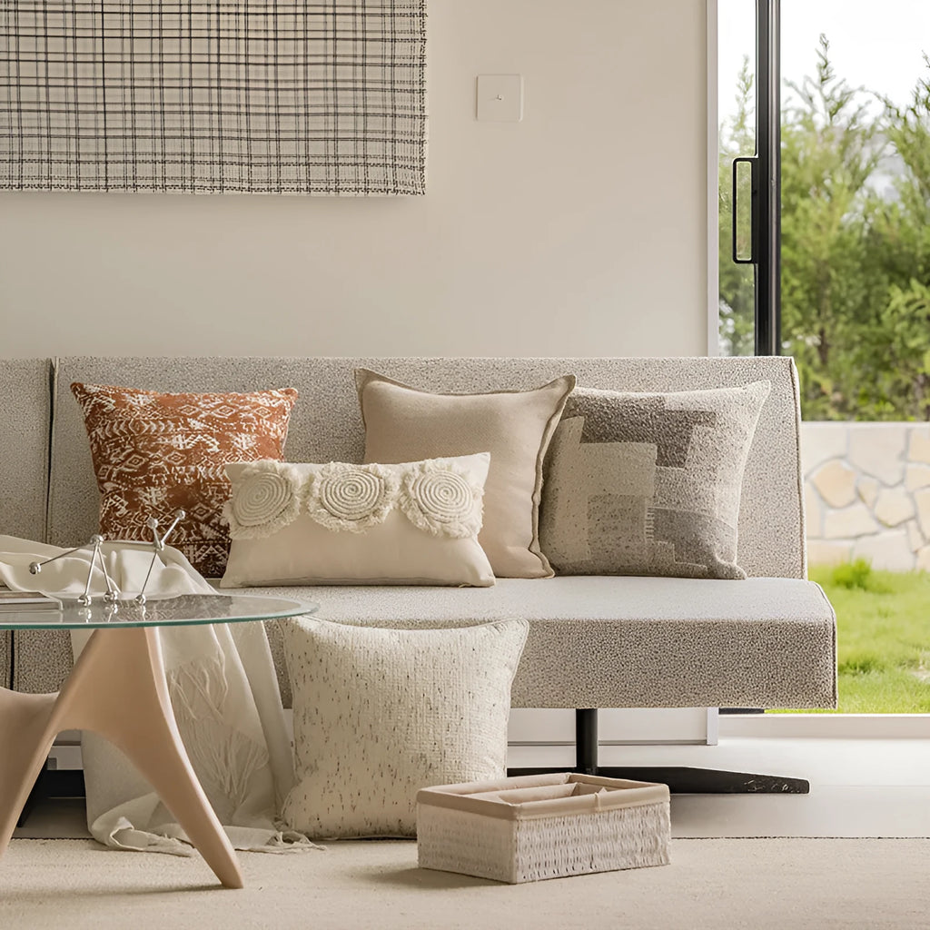 Solid colour decorative cushion on a sofa, showing its square shape and pp cotton filling.