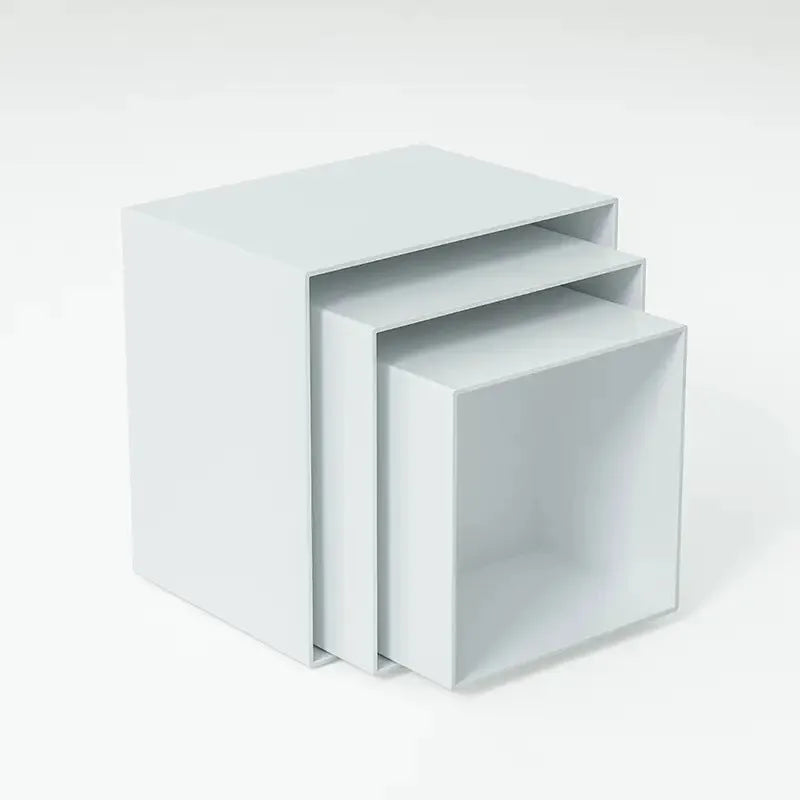 Six white plastic cube-shaped dessert display stands arranged in two rows for patisserie presentation
