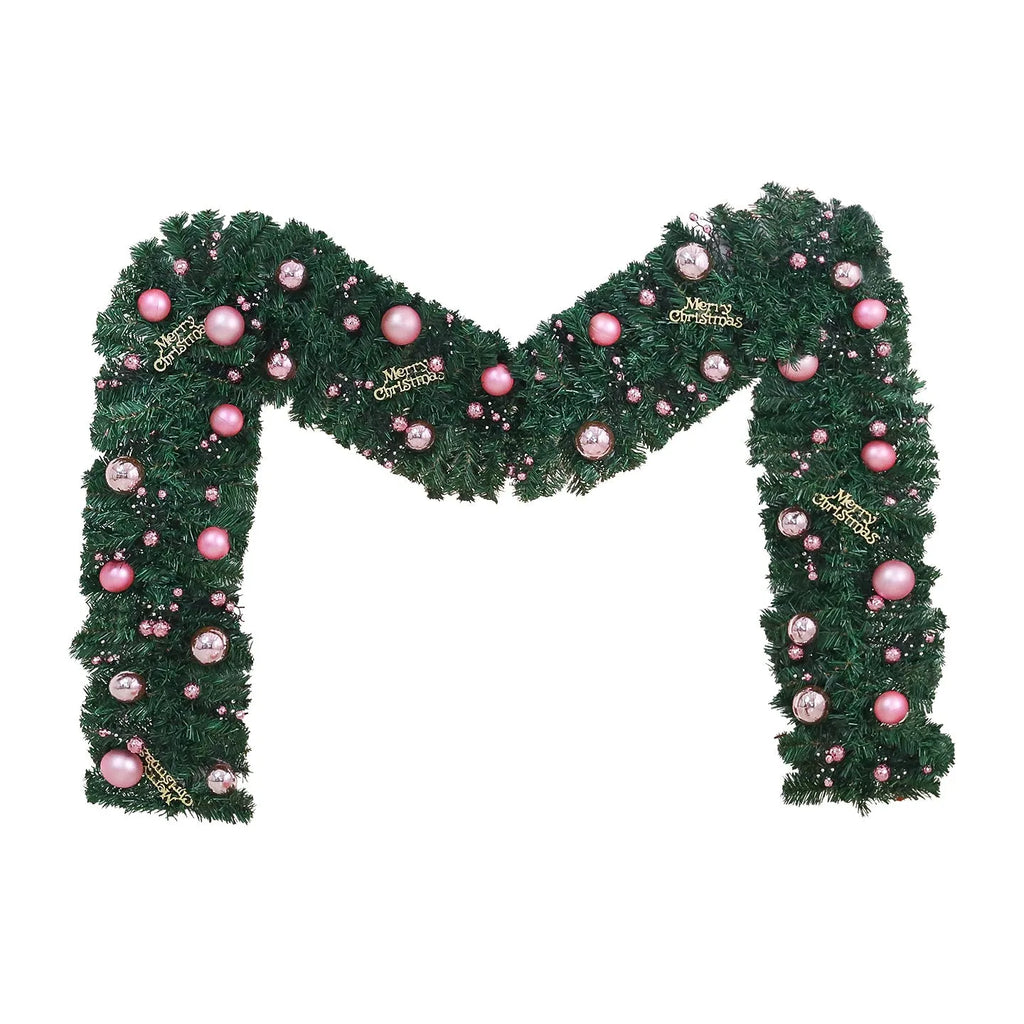 A long, pink artificial rattan Christmas garland with small fruits and leaves, shown draped decoratively.