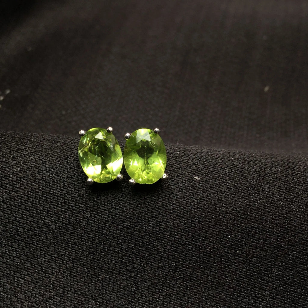 Natural grass green olivine stud earrings in S925 sterling silver with 6×8mm elliptical faceted gemstones.