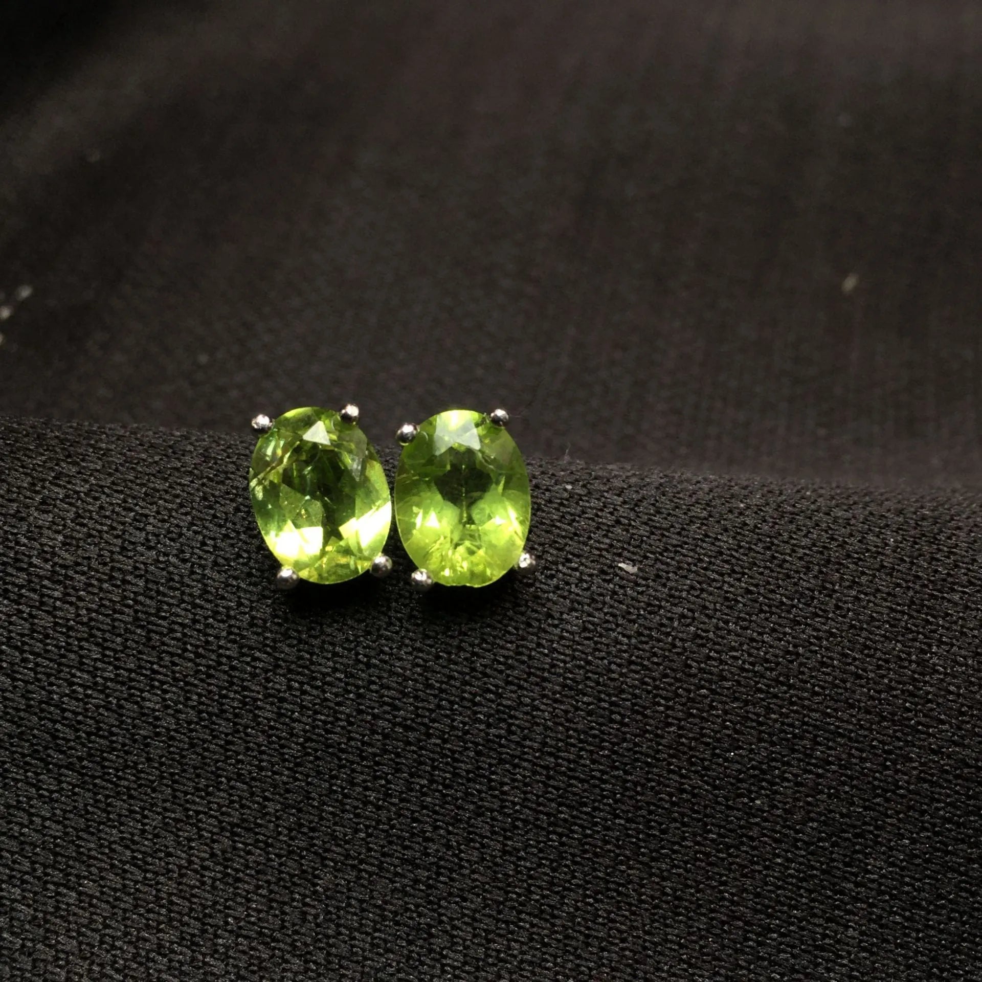 Natural grass green olivine stud earrings in S925 sterling silver with 6×8mm elliptical faceted gemstones.