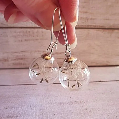 Transparent glass ball earrings with dandelion seed design on a silver French hook