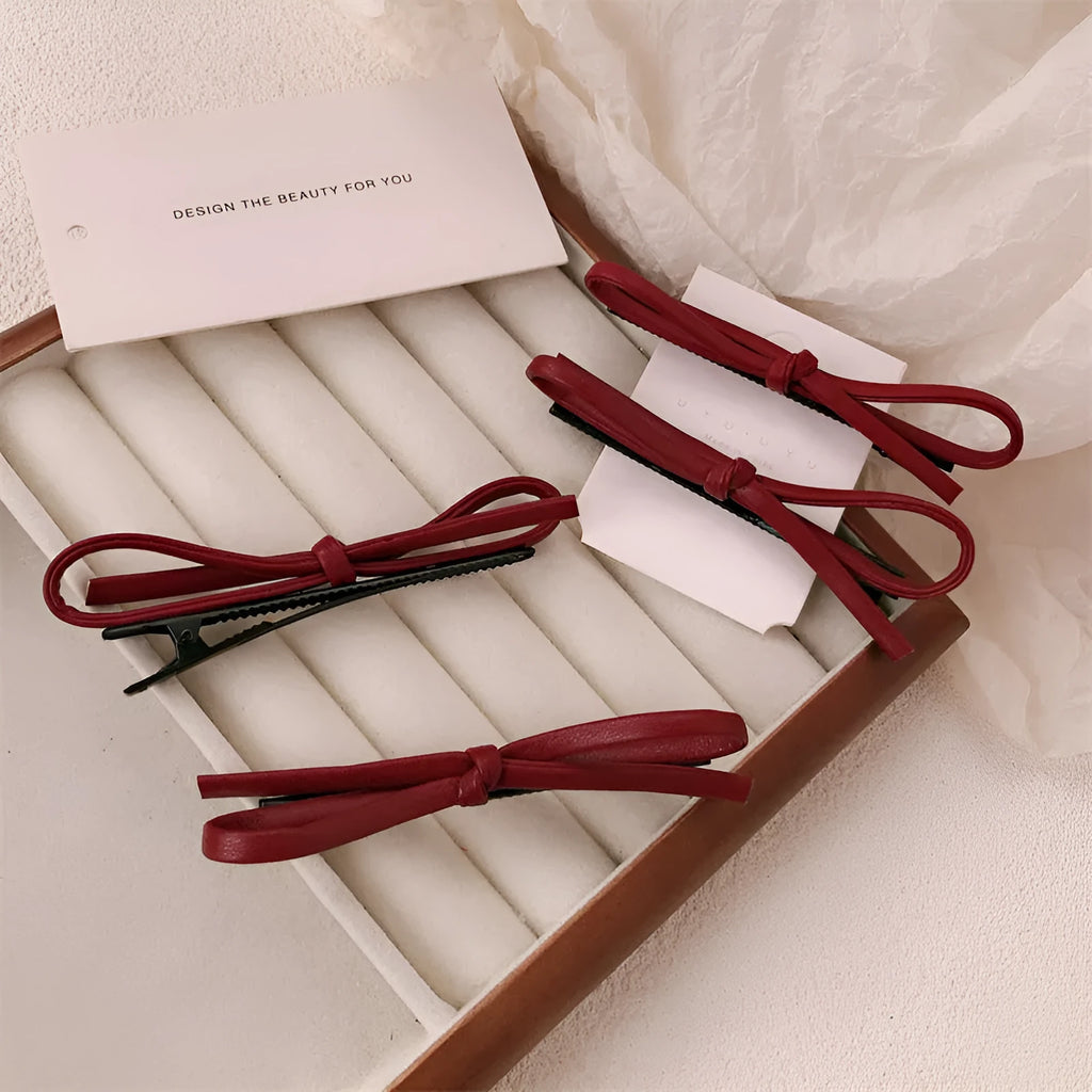 Wine red leather bow hair barrettes showing bow design and leather material