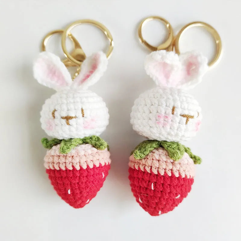 Hand-woven rabbit strawberry wire pendant with key attachment on white background