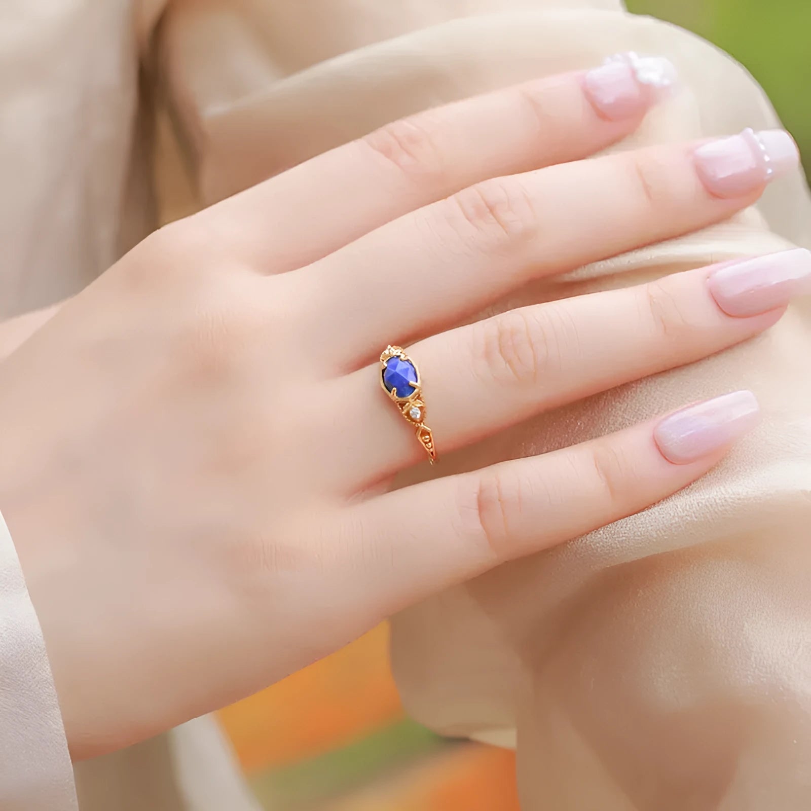Japanese geometric silver ring with elliptical face and round lapis lazuli stone showing forest night sky colour