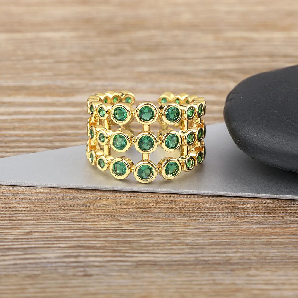 Copper wide band ring plated in 18K gold, fully set with green zircon stones.