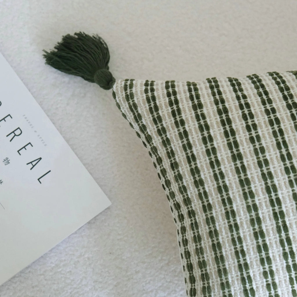 Green striped cotton linen hotel sample pillow with silk floss filler on a bed display.