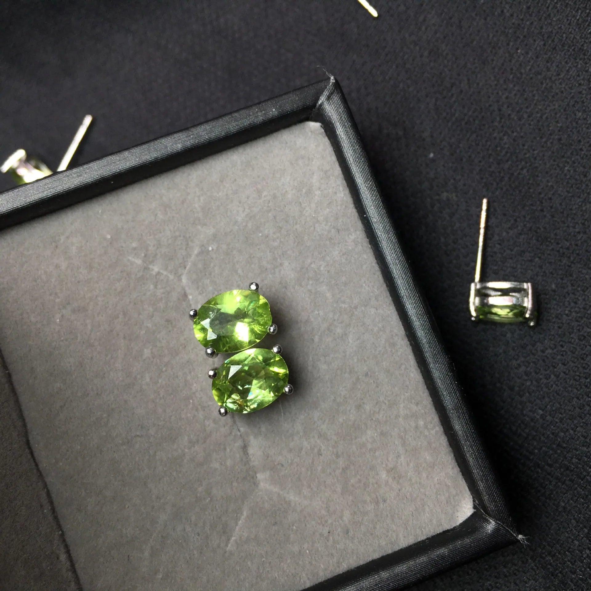 Natural grass green olivine stud earrings in S925 sterling silver with 6×8mm elliptical faceted gemstones.
