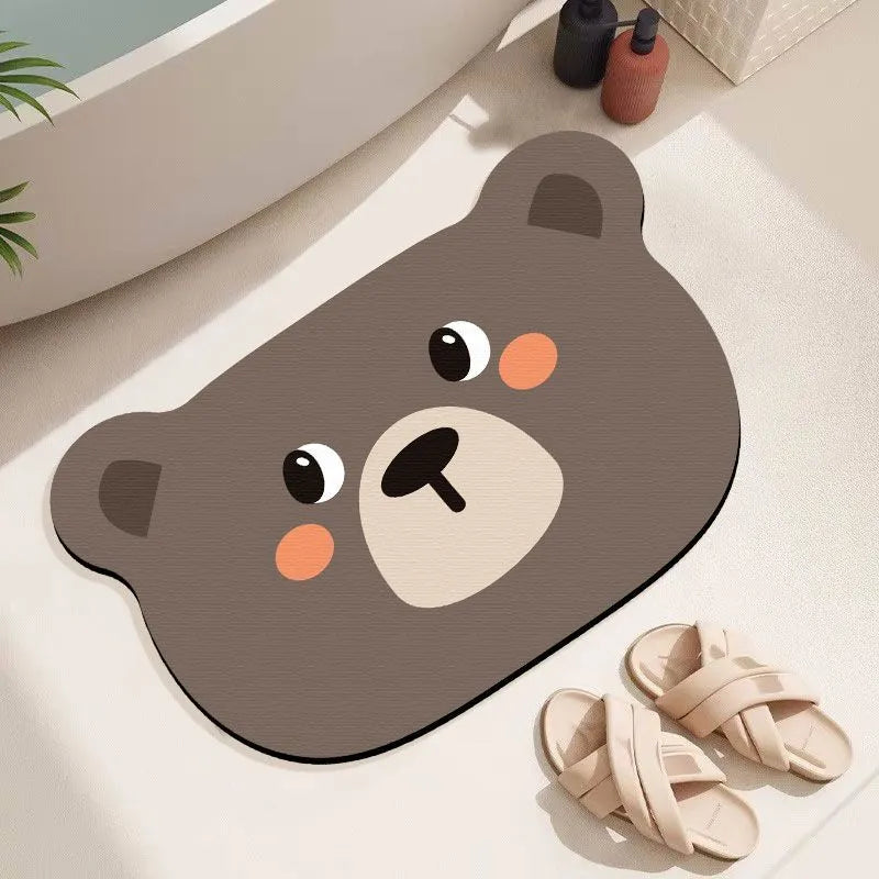 Cartoon animal diatom mud bathroom mat in Mr Brown Bear design on tiled floor.
