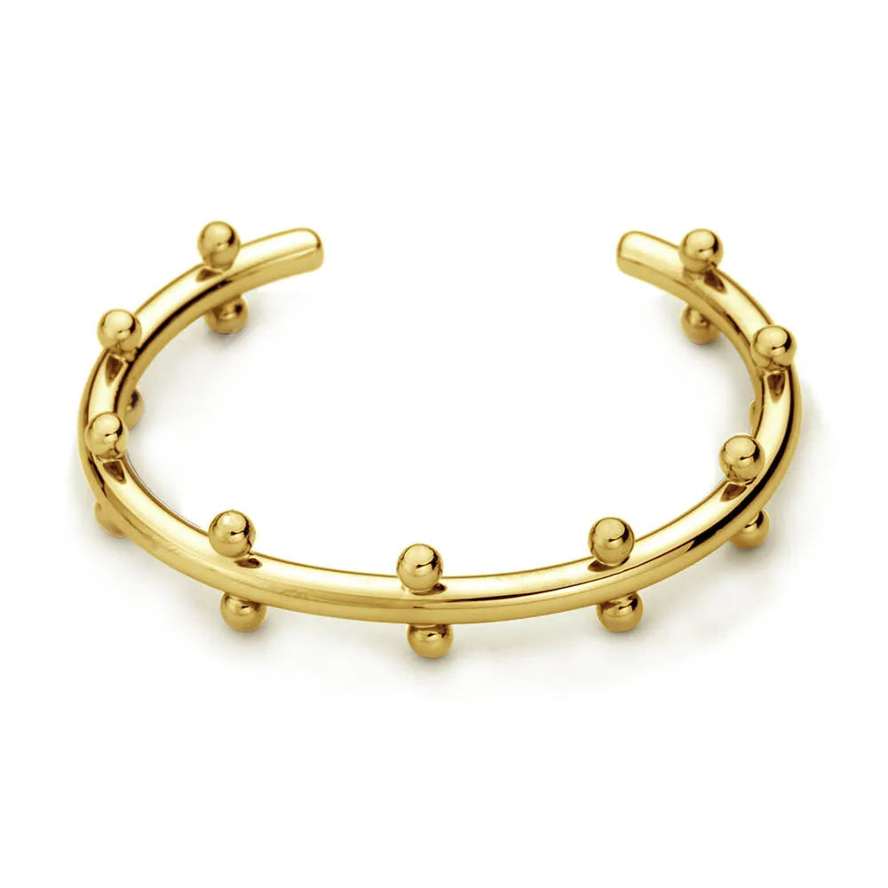 Stainless steel C-shaped bracelet with rivet-shaped bean beads in a steel-gold colour finish.