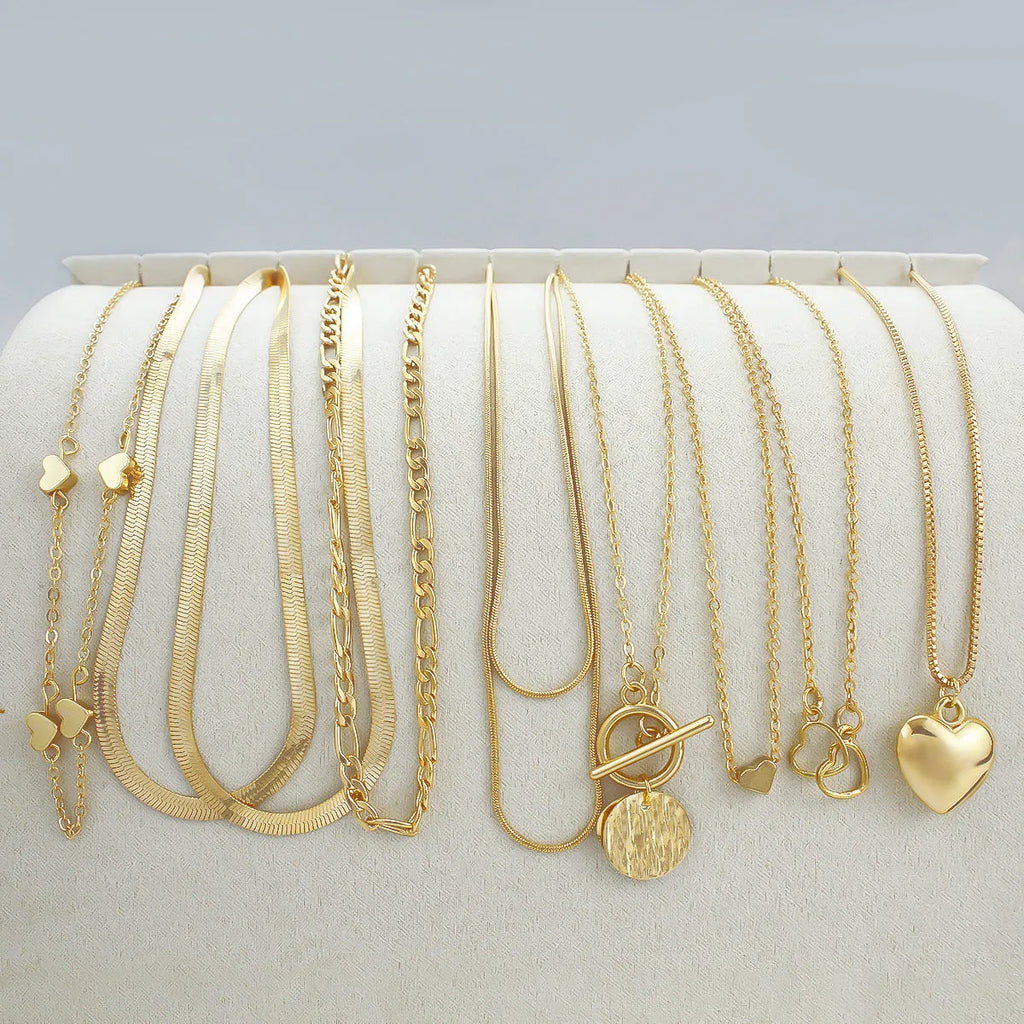 Ten gold electroplated necklaces with alloy pendants on adjustable snake bone chains