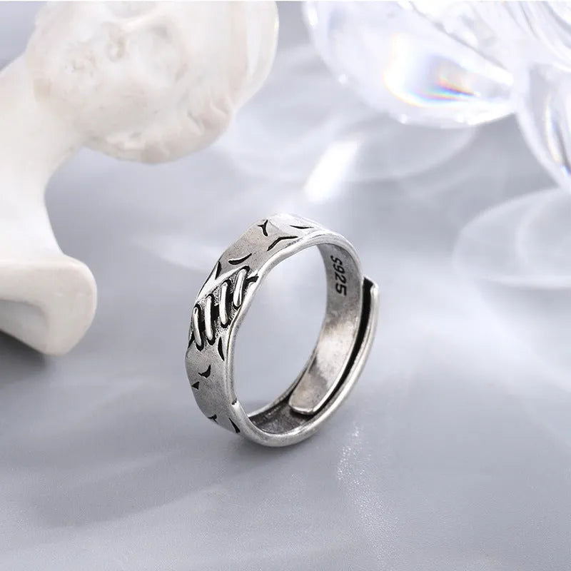 Black geometric copper ring for women with adjustable opening featuring round and oval elements