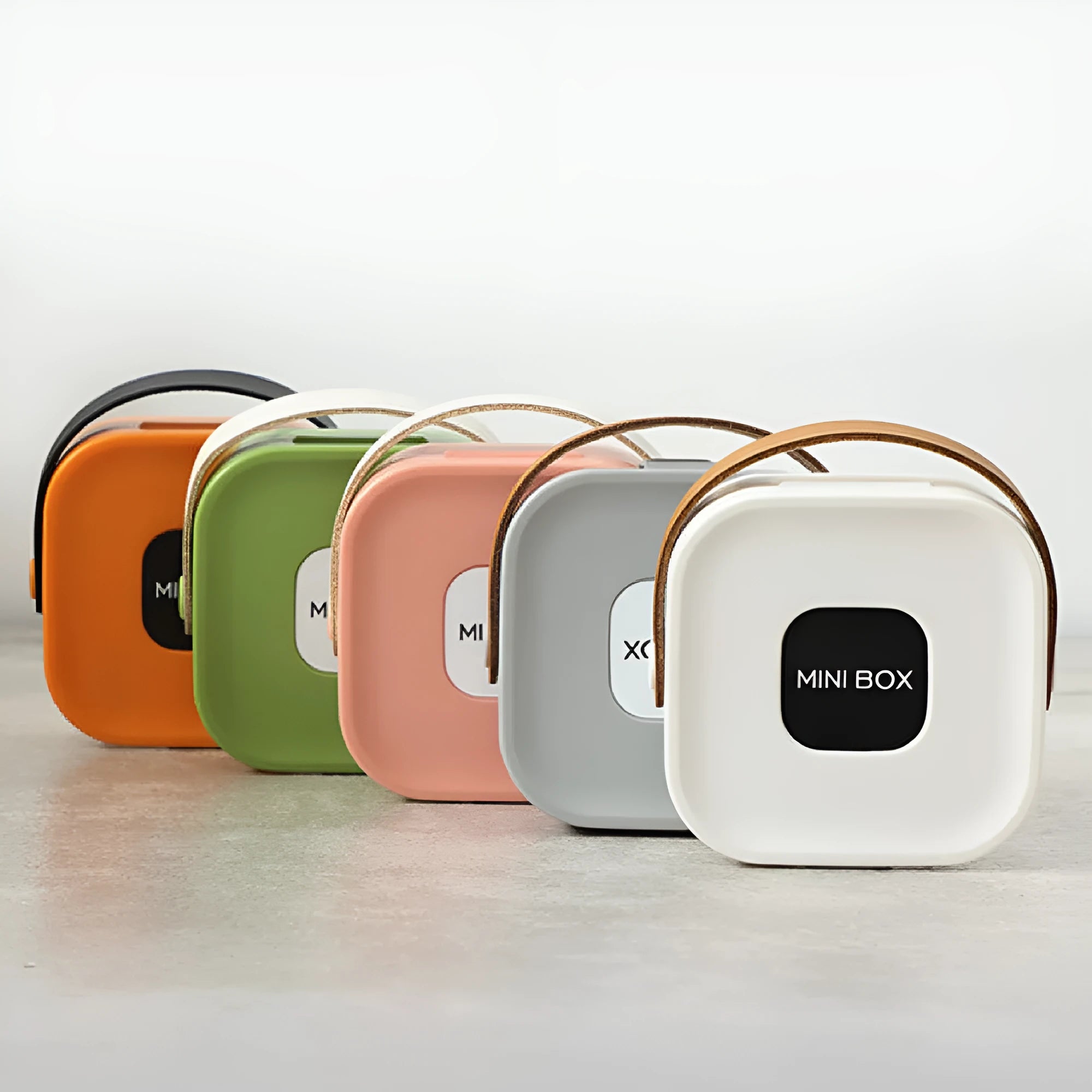 Medium-sized polypropylene storage box with a lid for organising cables and a Bluetooth headset.