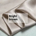 Double-sided solid colour silk duvet cover shown in Lotus Pink, pea green, bright brown, purple, white, or blue.
