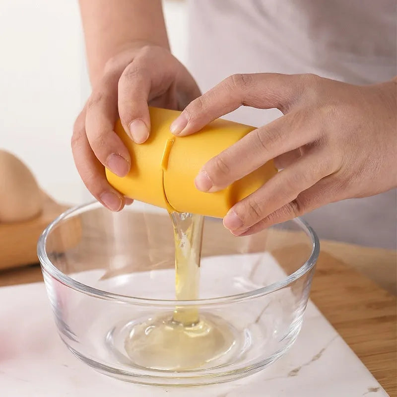 Egg shell opener and beater in pink with stainless steel mechanism on white background