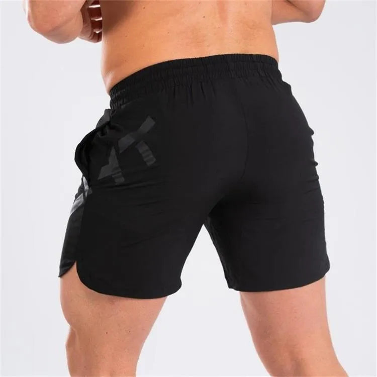 Man wearing black quick-dry nylon sports shorts with an elastic waistband, suitable for running and summer training.