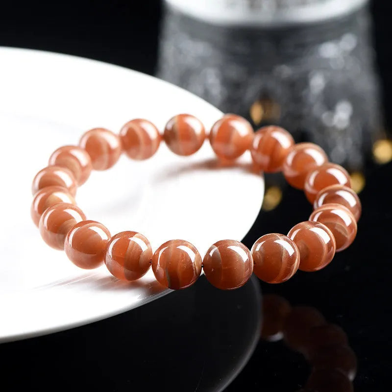 Natural Peruvian rhodochrosite bead bracelet with geometric design and ruyi element
