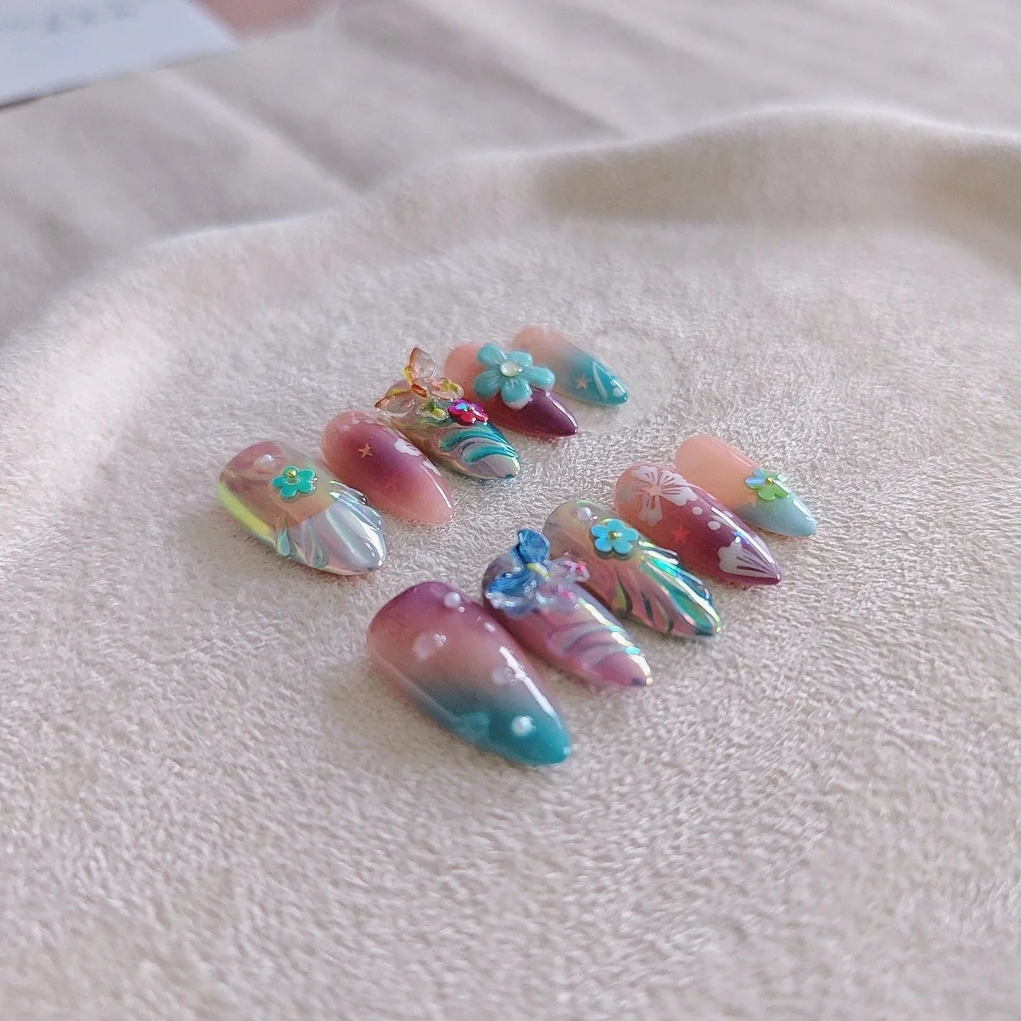 Handmade nail art sculptures with colourful embossed flower and butterfly designs